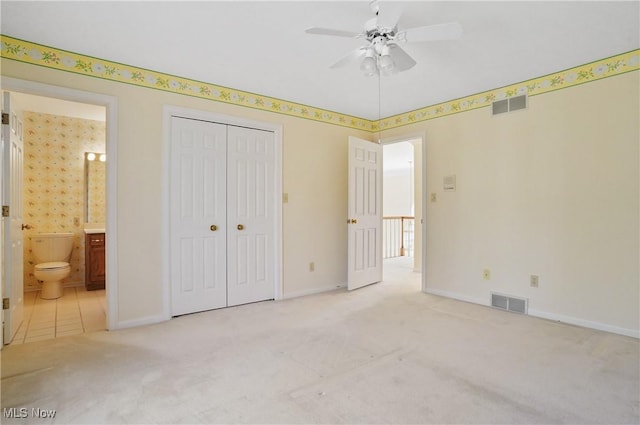 3773 N Shore Dr, Akron, OH 44333 - unfurnished bedroom featuring carpet floors, a closet, ensuite bath, and a ceiling fan