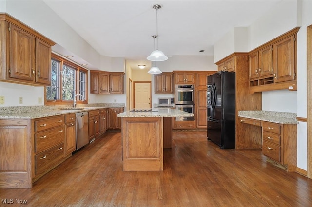 3773 N Shore Dr, Akron, OH 44333 - kitchen with appliances with stainless steel finishes, dark wood finished floors, brown cabinets, and a center island