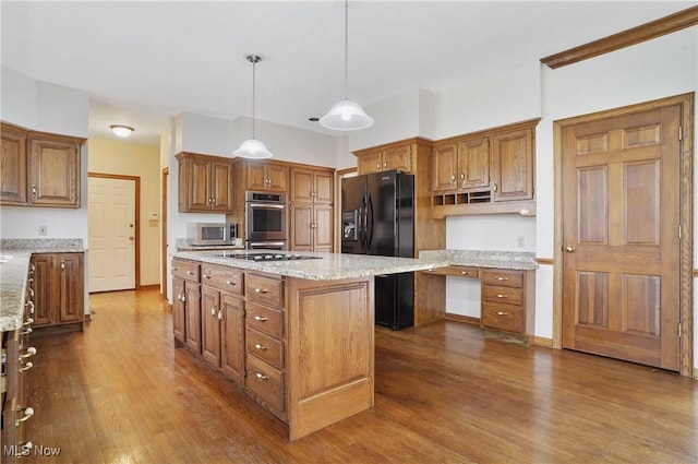 3773 N Shore Dr, Akron, OH 44333 - kitchen featuring appliances with stainless steel finishes, dark wood-type flooring, a center island, and brown cabinetry