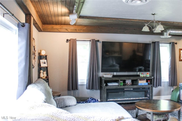 6221 Gault Rd, Canfield, OH 44406 - living area featuring healthy amount of natural light, a chandelier, and wood ceiling