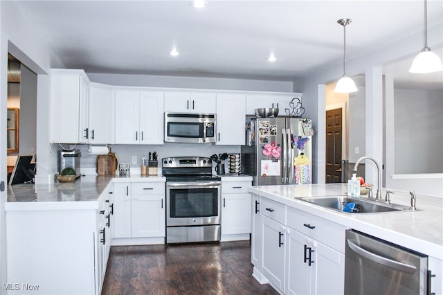 6221 Gault Rd, Canfield, OH 44406 - kitchen with stainless steel appliances, hanging light fixtures, white cabinets, dark wood-type flooring, and recessed lighting