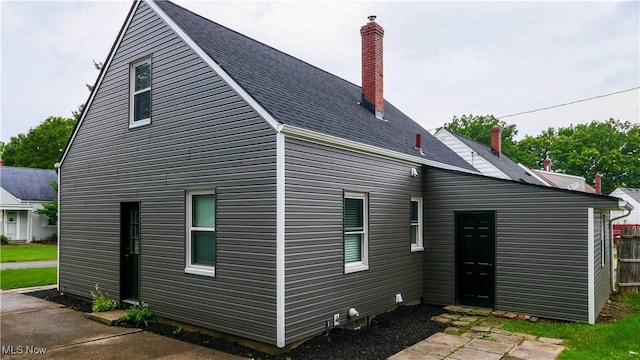 2405 Harding Rd, Cuyahoga Falls, OH 44223 - back of house with a chimney and roof with shingles