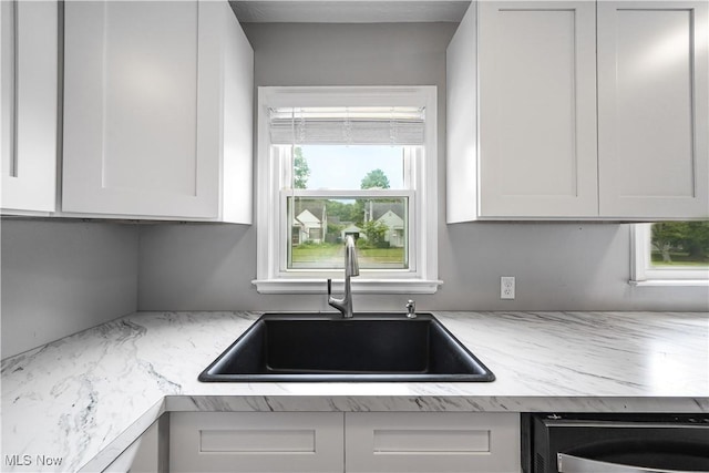 2405 Harding Rd, Cuyahoga Falls, OH 44223 - kitchen with dishwasher, white cabinets, and light stone counters