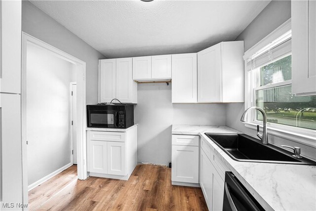 2405 Harding Rd, Cuyahoga Falls, OH 44223 - kitchen with black microwave, white cabinetry, and light wood-type flooring