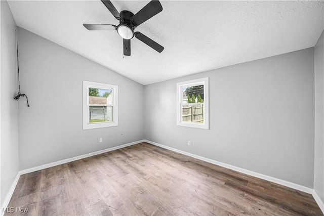 2405 Harding Rd, Cuyahoga Falls, OH 44223 - empty room with wood finished floors, lofted ceiling, a textured ceiling, and ceiling fan