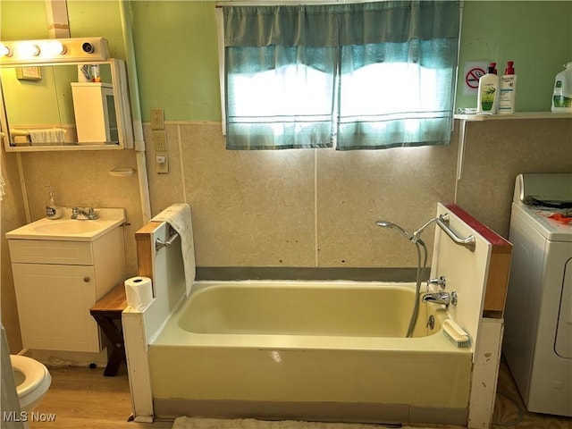 1209 Camden Ave, Parkersburg, WV 26101 - full bathroom with washer / clothes dryer, vanity, a garden tub, and wood finished floors