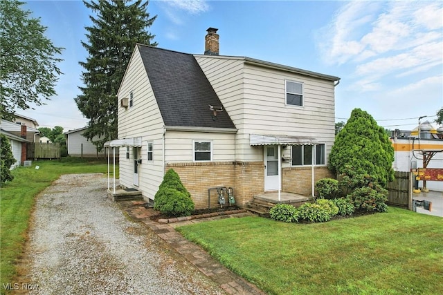16-18 E Linwood Ave, Akron, OH 44301 - view of front facade with a chimney, brick siding, driveway, and a shingled roof