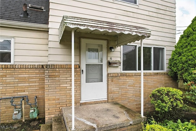 16-18 E Linwood Ave, Akron, OH 44301 - view of exterior entry with brick siding and roof with shingles