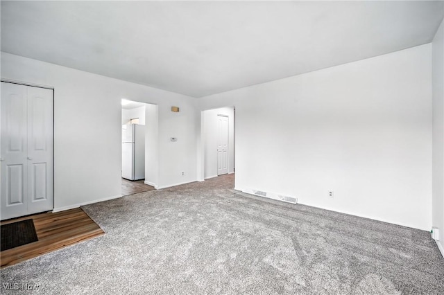 16-18 E Linwood Ave, Akron, OH 44301 - unfurnished bedroom with freestanding refrigerator and carpet flooring