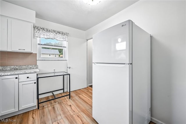16-18 E Linwood Ave, Akron, OH 44301 - kitchen featuring freestanding refrigerator, light wood-style floors, backsplash, and white cabinets