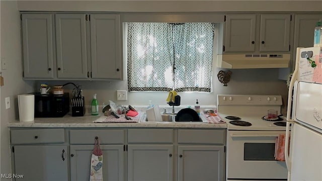 467 Elm St, Struthers, OH 44471 - kitchen featuring white appliances, under cabinet range hood, light countertops, and gray cabinets