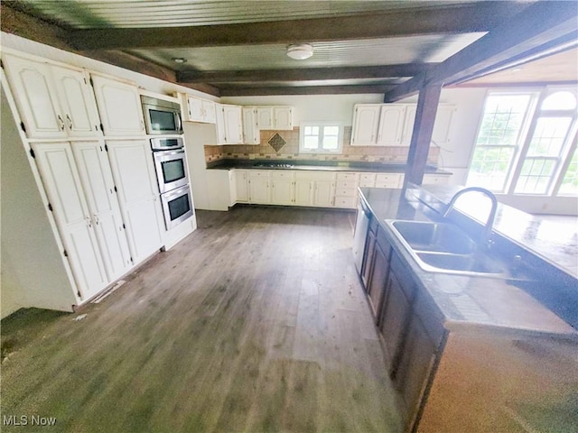 56612 Mcgee Rd, Shadyside, OH 43947 - kitchen featuring stainless steel appliances, beamed ceiling, white cabinetry, dark wood-style floors, and tasteful backsplash