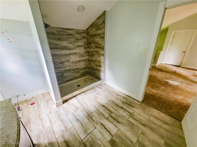 56612 Mcgee Rd, Shadyside, OH 43947 - full bathroom with a tile shower, wood finish floors, and lofted ceiling