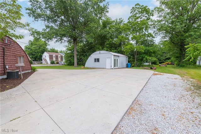 4465 Oberlin Ave, Lorain, OH 44053 - view of patio with concrete driveway and a storage shed