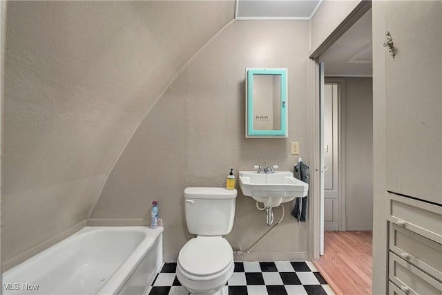 4465 Oberlin Ave, Lorain, OH 44053 - bathroom featuring tile patterned floors, lofted ceiling, and a bath