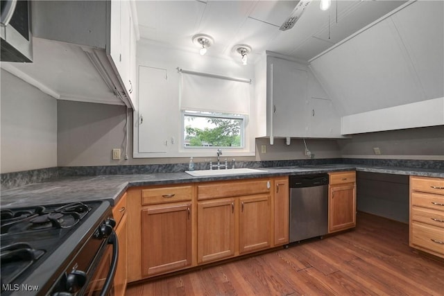 4465 Oberlin Ave, Lorain, OH 44053 - kitchen featuring appliances with stainless steel finishes, dark wood-type flooring, dark countertops, lofted ceiling, and brown cabinets
