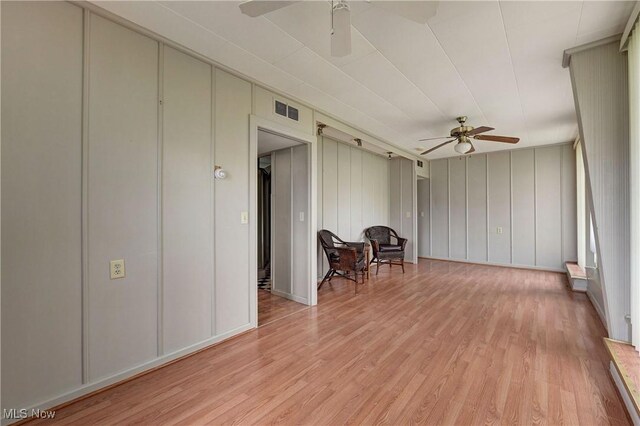 4465 Oberlin Ave, Lorain, OH 44053 - living area with a ceiling fan, a decorative wall, and light wood finished floors