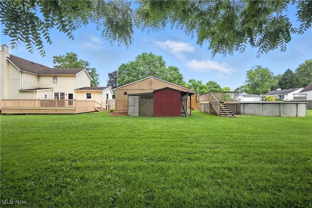 77 W Park Ave, Hubbard, OH 44425 - view of green lawn featuring a wooden deck, an outdoor pool, and a shed