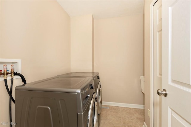 101 Stonegate Cir, Seven Hills, OH 44131 - laundry room featuring washer and dryer and light tile patterned floors