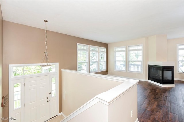 101 Stonegate Cir, Seven Hills, OH 44131 - foyer featuring dark wood-style flooring and a multi sided fireplace