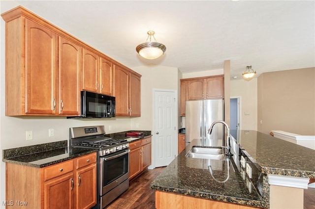 101 Stonegate Cir, Seven Hills, OH 44131 - kitchen featuring appliances with stainless steel finishes, an island with sink, dark wood-style floors, and dark stone counters