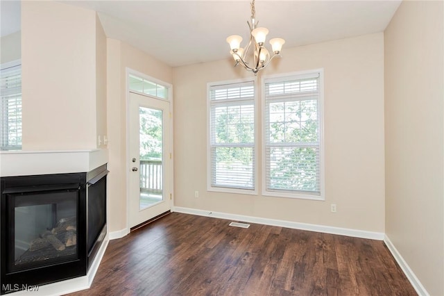 101 Stonegate Cir, Seven Hills, OH 44131 - unfurnished dining area featuring a chandelier, dark wood-style flooring, and a multi sided fireplace