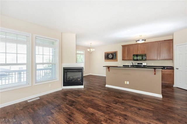 101 Stonegate Cir, Seven Hills, OH 44131 - kitchen featuring black microwave, dark countertops, a breakfast bar, a chandelier, and dark wood finished floors