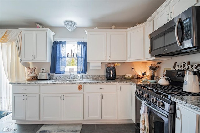 6470 Duncan Dr, Poland, OH 44514 - kitchen with stainless steel appliances, tile patterned flooring, white cabinetry, and light stone counters