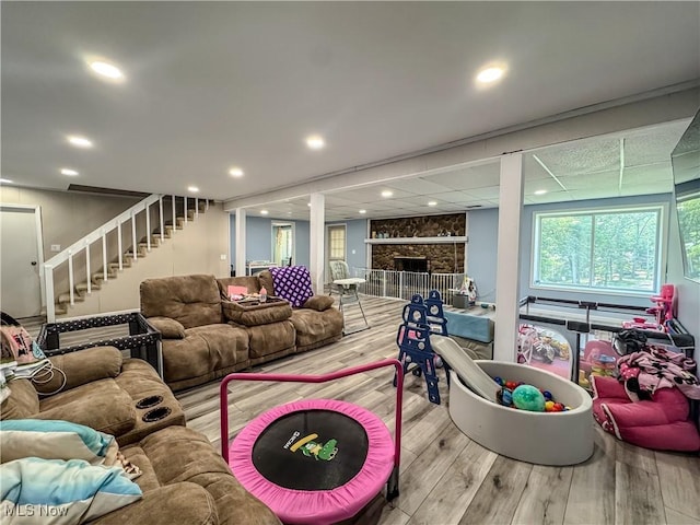 38 Lake Dr, Parkersburg, WV 26104 - living area with stairs, wood finished floors, recessed lighting, and a fireplace