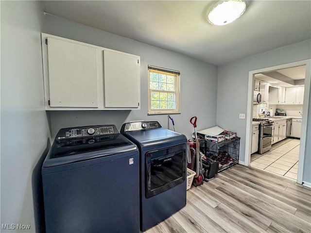 38 Lake Dr, Parkersburg, WV 26104 - laundry area with cabinet space, separate washer and dryer, and light wood-type flooring