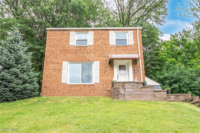 24690 Hawthorne Dr, Euclid, OH 44117 - view of front facade featuring brick siding and a front yard
