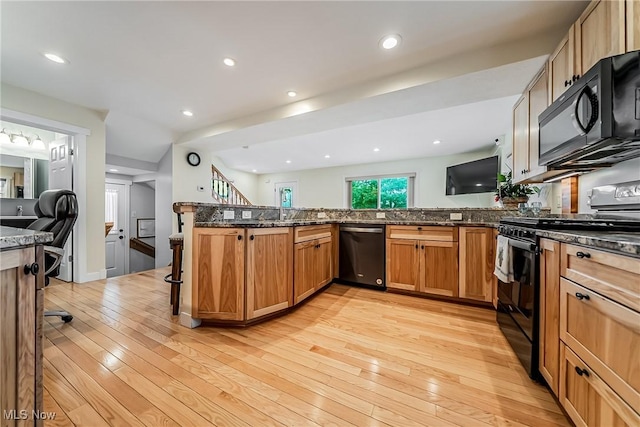 24690 Hawthorne Dr, Euclid, OH 44117 - kitchen with black appliances, light wood finished floors, dark stone countertops, a peninsula, and recessed lighting