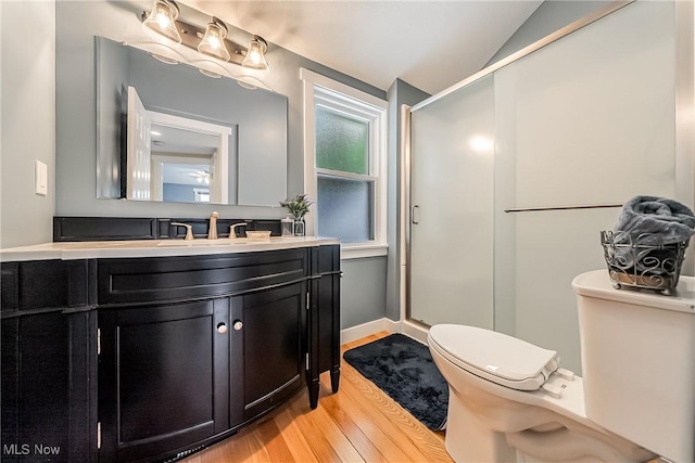 24690 Hawthorne Dr, Euclid, OH 44117 - full bathroom with wood finished floors, vanity, a stall shower, and vaulted ceiling