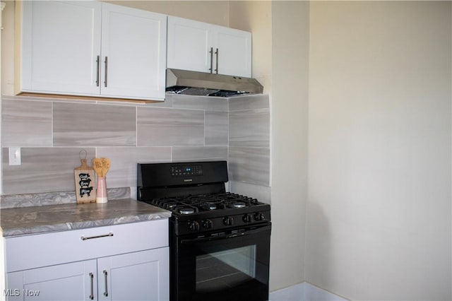 2951 Toledo Ave, Lorain, OH 44055 - kitchen featuring black gas range oven, under cabinet range hood, backsplash, and white cabinetry