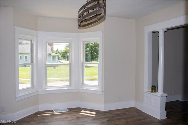 2951 Toledo Ave, Lorain, OH 44055 - unfurnished dining area featuring dark wood-style floors and baseboards