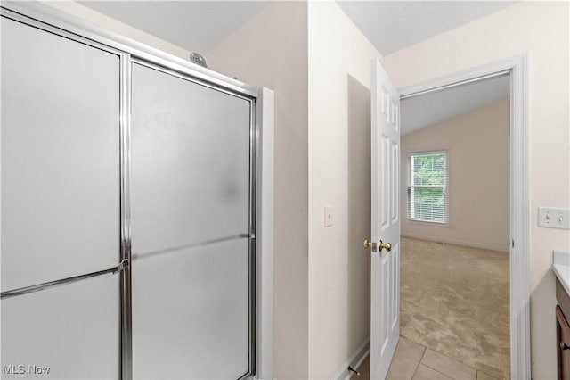4877 Highland Place Ct, Richmond Heights, OH 44143 - full bath with vanity, a shower stall, tile patterned floors, and lofted ceiling