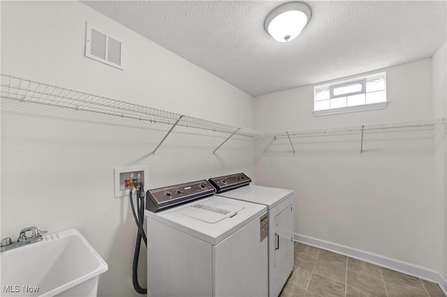 4877 Highland Place Ct, Richmond Heights, OH 44143 - washroom featuring separate washer and dryer and a textured ceiling