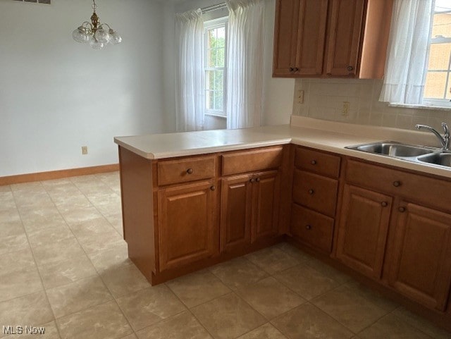 120 Braxton Rd, Weirton, WV 26062 - kitchen with plenty of natural light, brown cabinets, a peninsula, and a chandelier
