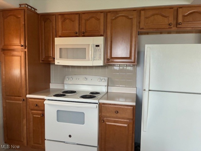 120 Braxton Rd, Weirton, WV 26062 - kitchen with white appliances, light countertops, and brown cabinets
