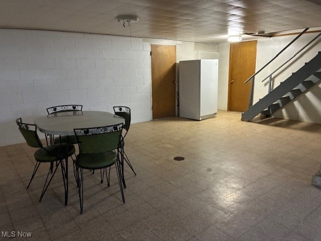 120 Braxton Rd, Weirton, WV 26062 - dining room with tile patterned floors, stairway, and concrete block wall