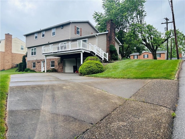 224 N Hills Dr, Parkersburg, WV 26104 - view of front of house with an attached garage, a front lawn, concrete driveway, a wooden deck, and a chimney