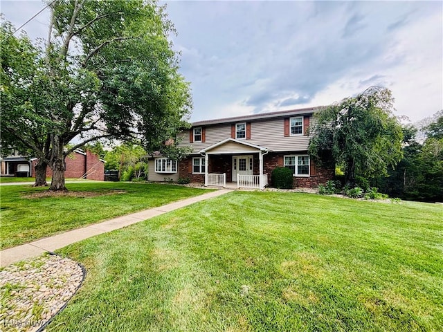 224 N Hills Dr, Parkersburg, WV 26104 - view of front of home featuring brick siding, a front yard, and a porch