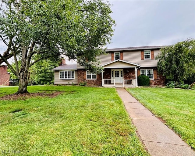 224 N Hills Dr, Parkersburg, WV 26104 - view of front of property featuring a front lawn, a chimney, and covered porch