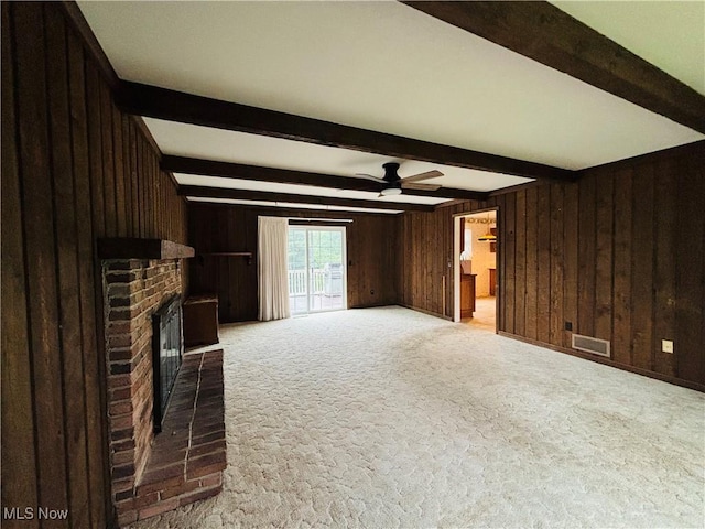 224 N Hills Dr, Parkersburg, WV 26104 - unfurnished living room featuring beam ceiling, wood walls, carpet, a ceiling fan, and a fireplace
