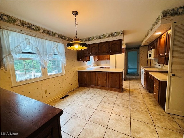 224 N Hills Dr, Parkersburg, WV 26104 - kitchen featuring white appliances, a peninsula, wallpapered walls, light countertops, and decorative light fixtures