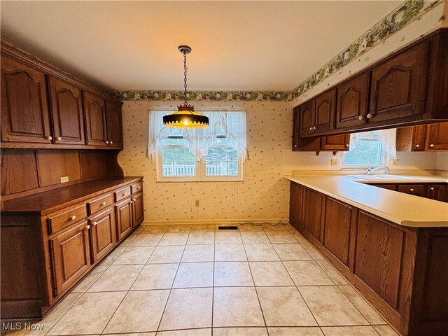224 N Hills Dr, Parkersburg, WV 26104 - kitchen with wallpapered walls, decorative light fixtures, and light countertops