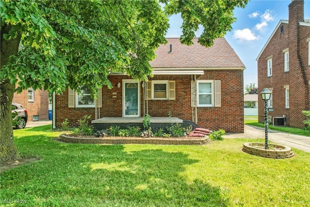 565 12th St, Campbell, OH 44405 - view of front facade with brick siding, a front yard, a shingled roof, and a porch