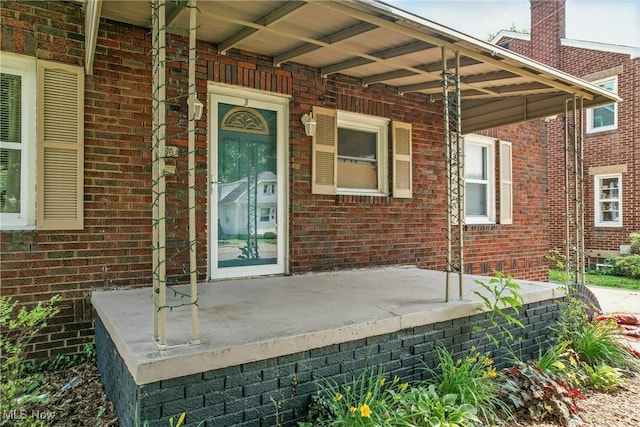 565 12th St, Campbell, OH 44405 - doorway to property with covered porch and brick siding