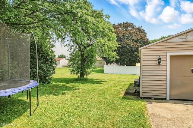 565 12th St, Campbell, OH 44405 - view of yard with a trampoline and a garage
