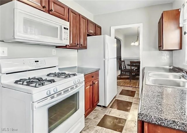565 12th St, Campbell, OH 44405 - kitchen with white appliances and dark countertops